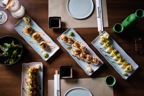 a table with four plates of food on it at Hotel Indigo Grand Cayman by IHG in Grand Cayman