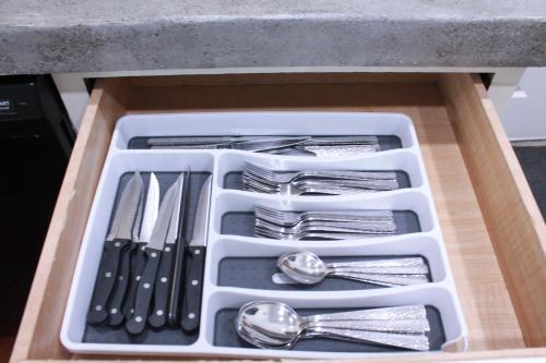 a tray of utensils in a drawer under a counter at Setting the right vibes. in Killeen