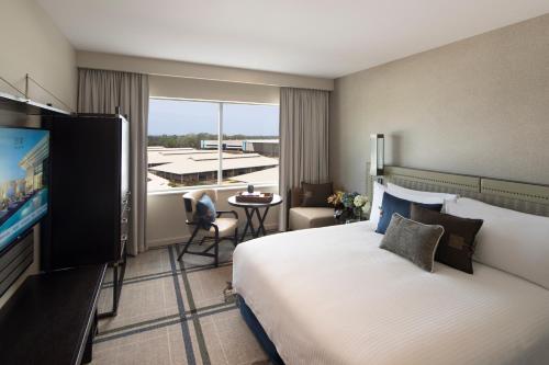 a hotel room with a large bed and a television at The William Inglis Mgallery in Warwick Farm
