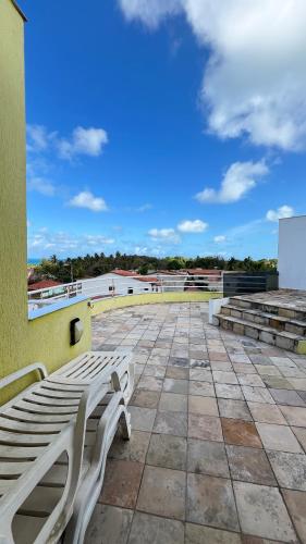 a white bench sitting on top of a roof at Ocean view apart inteiro lazer privativa in Nísia Floresta