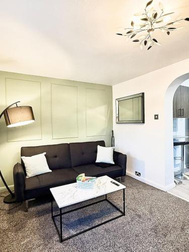 a living room with a couch and a table at Watford Stay Comfortable Home Near Town Centre and Transport in Watford