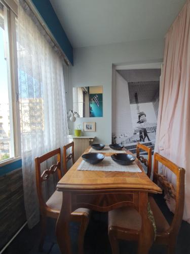 a wooden table in a dining room with chairs at Orangerie de la Défense in Puteaux