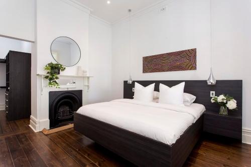 a bedroom with a bed with a fireplace and a mirror at Norwood Haven- Pool - Pet Friendly & Free WiFi in Norwood