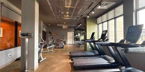 a gym with a bunch of treadms and cardio machines at Hotel Indigo Traverse City by IHG in Traverse City