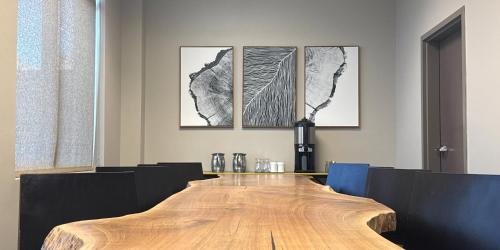 a large wooden table in a room with paintings on the wall at Hotel Indigo Traverse City by IHG in Traverse City