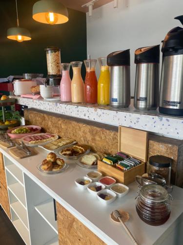 a buffet with many different types of food on a counter at G Hotel by Gaya Group in Santa Cruz de la Sierra