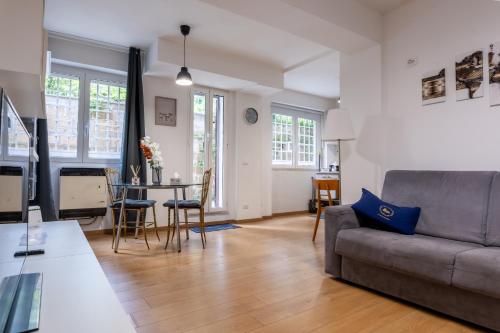 a living room with a couch and a table at La Dolce Roma - Relax & Comfort in Rome