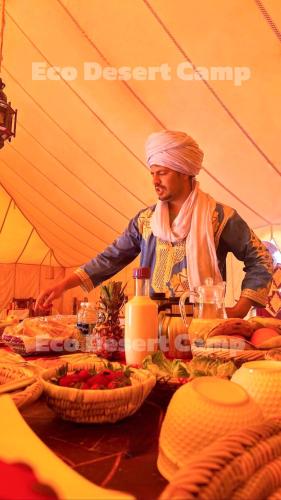 a woman standing at a table in a tent at Eco Desert Camp in Merzouga