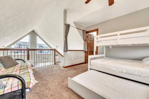 a bedroom with two beds and a balcony at The Anchor Poolside at Bridges Bay Resort in Arnolds Park