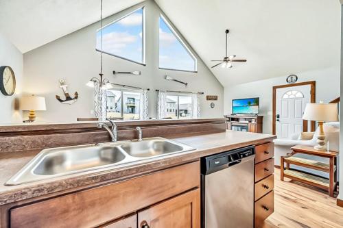 a kitchen with a sink and a window at The Anchor Poolside at Bridges Bay Resort in Arnolds Park