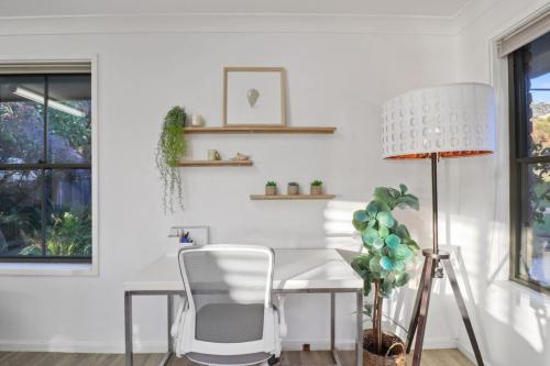 a white dining room with a table and chairs at Sealand Retreat in Fishing Point