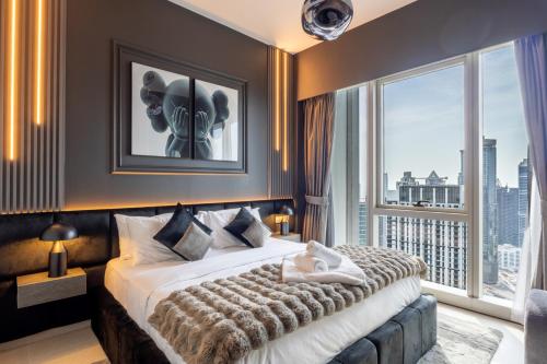 a bedroom with a large bed and a large window at Luxury 1-Bedroom, High-Floor, Skyline Views in Dubai