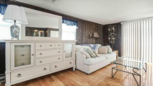 a living room with a white dresser with a mirror at Wi-Fi, Yes To Pets, Patio, Private Yard, Beach Chairs,balcony, Beach Badges, Outside Shower, Decks,,large 5 Bedroom 2 Bath Bayside Cape, in Ship Bottom