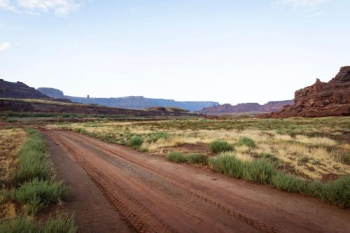 a dirt road in the middle of the desert at Glamping Family Tent At Private Riverside Ranch in Moab