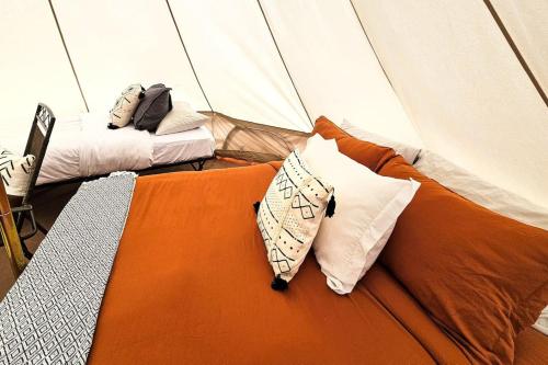 a room with two beds with pillows in a tent at Glamping Family Tent At Private Riverside Ranch in Moab