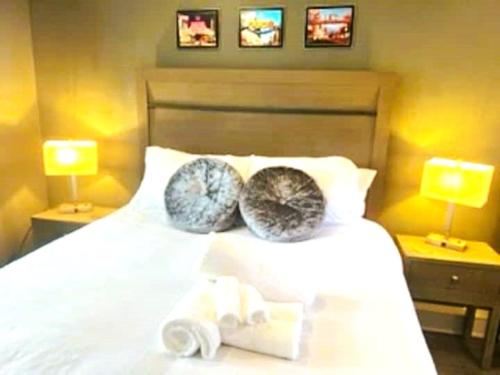 a bedroom with a white bed with two pillows on it at Reno Romantic Couples Retreat in Reno