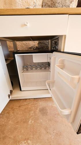 an open drawer in a white cabinet with the door open at The Caves at Moab - At Private Riverside Ranch in Moab