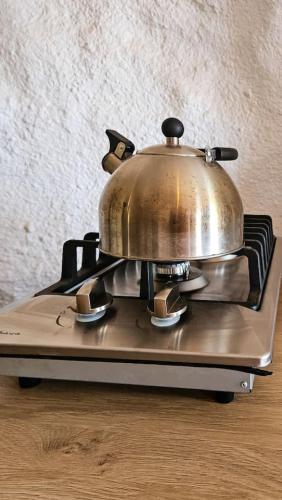 a tea pot sitting on top of a stove at The Caves at Moab - At Private Riverside Ranch in Moab
