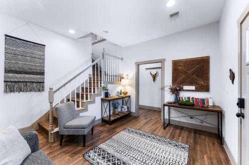 a living room with white walls and a stairway at Boerne Gem Near Downtown River Park Main Street in Boerne