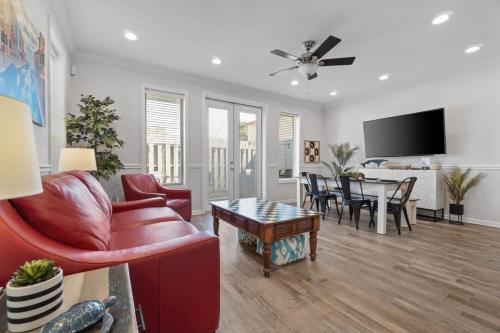 a living room with a red couch and a table at Panama City Beach Home - Few steps from the shores in Panama City Beach