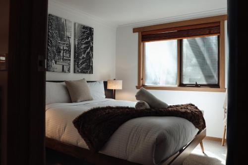 a bedroom with a bed with a blanket on it at Dibbin’s Chalet in Dinner Plain