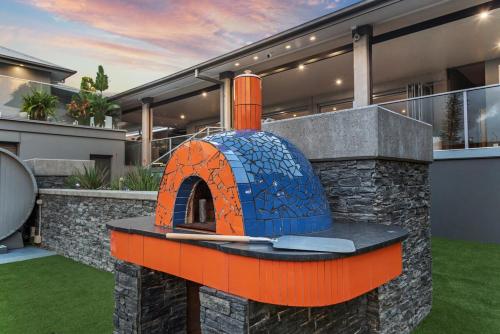 an orange and blue oven in front of a house at The Sands on Margate Beach in Woody Point