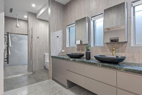 two sinks on a counter in a bathroom at The Sands on Margate Beach in Woody Point