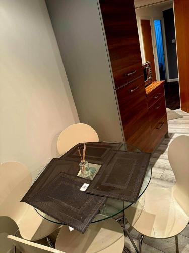 a glass table in a room with white chairs at Luxury 2 bedroom apartment in Aberdeen in Kirkton of Skene