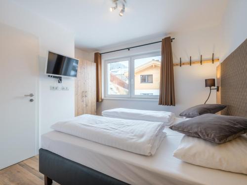 two beds in a bedroom with a window at Werfenblick in Werfenweng