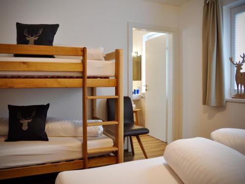 a room with two bunk beds and a chair at Bergblick in Werfenweng