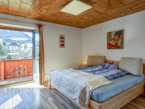 a bedroom with a bed and a large window at Gästehaus Staffner in Sonnberg