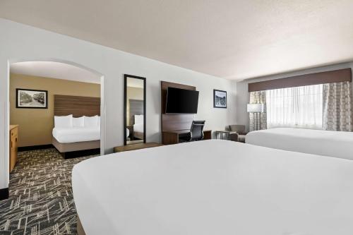 a hotel room with two beds and a television at Best Western Plus Caldwell Inn & Suites in Caldwell