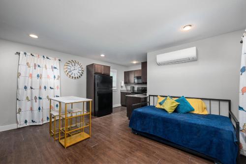 a bedroom with a bed and a kitchen at Cozy Sanctuary Near MedCenter, UH and NRG in Houston