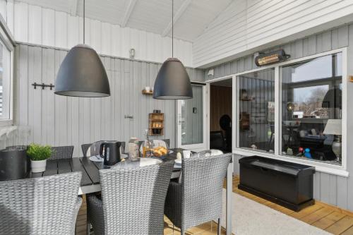 a dining room with a table and chairs at Feriehus 1109 in Ulfborg