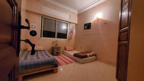 a small room with a bed and a couch at SK Homestay in Casablanca