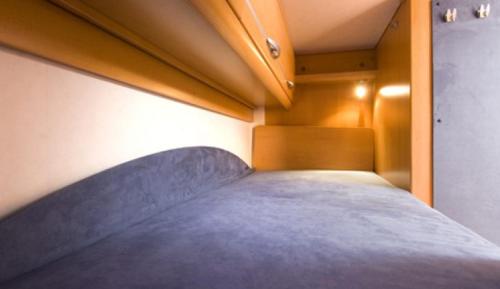 a bed in a room with avertisementatronatronstrationstrationstrationstration at Hymer CamperVan in Lisbon