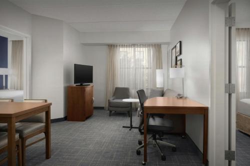 a hotel room with a desk and a television at Residence Inn Phoenix North Happy Valley in Phoenix