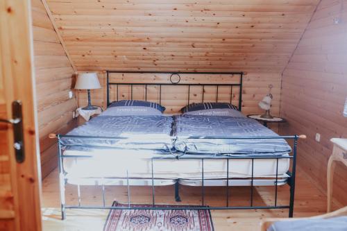 a bedroom with a bed in a wooden cabin at Holiday house with a swimming pool Gospic, Velebit - 21753 in Gospić