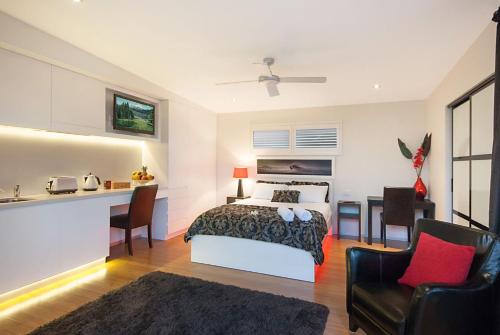 a bedroom with a bed and a table and chairs at Cavvanbah - Gypsy Villa in Byron Bay