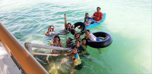 a group of people in the water on tubes at JRM Place in Oslob