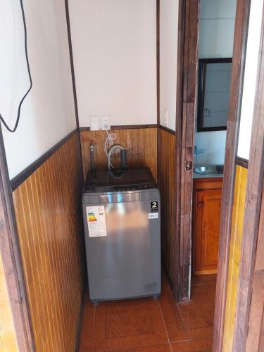 a small refrigerator in a room with a sink at Cabaña privada con acceso a playa in Quilquico