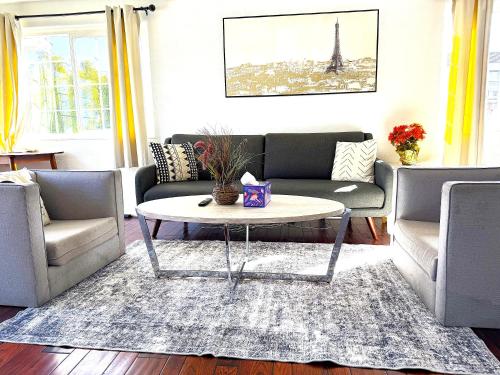 a living room with two couches and a coffee table at 40223 Fremont Entire Coze 3brs house Free Parking nd AC in Fremont