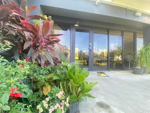 a house with plants and flowers in front of it at Wangan 175 B&B in Shui-wa-chüeh