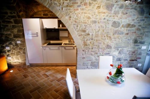 a table with a bottle on it in a kitchen at Umbria nel cuore in Cannara