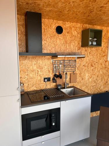a kitchen with a sink and a stove top oven at The 9 acre in Midleton