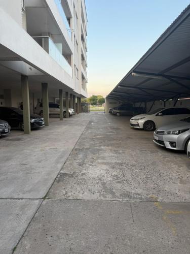 a group of cars parked in a parking lot at Departamento 3 Habitaciones Zona Cincuentenario in Formosa
