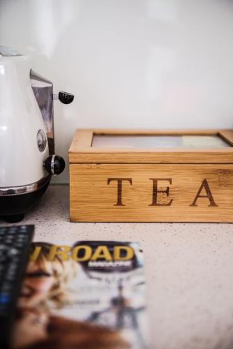 a wooden box with the word itzona next to a magazine at Cavvanbah - Rio Villa - Construction Zone Warning in Byron Bay