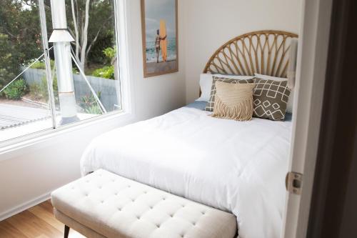 a bedroom with a bed and a window at Rockpool at Maslins Beach in Maslin Beach