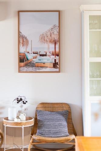 a room with a chair and a table and a mirror at Rockpool at Maslins Beach in Maslin Beach