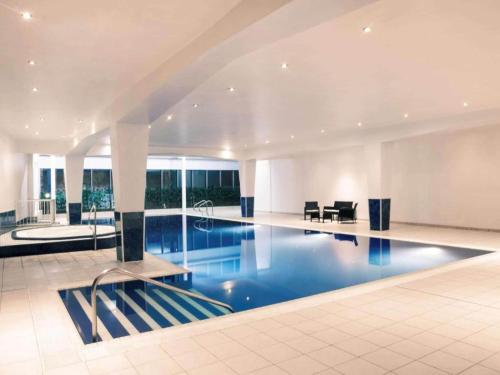 a large swimming pool in a large building at Central Cardiff Signature Collection by Dancenter in Cardiff